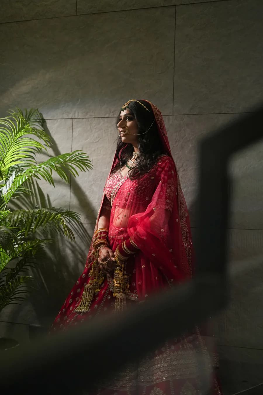 Indian Christian bride and groom exchanging vows in church with stained glass light