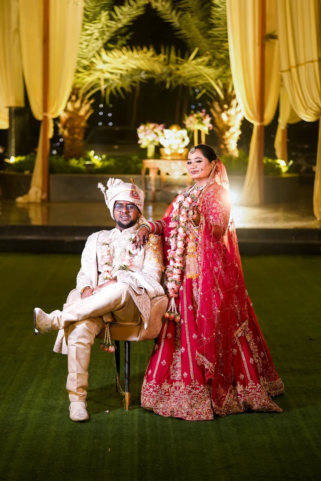 Couple in red wedding attire outdoors — candid wedding photography, Lens9 Studio, New Delhi