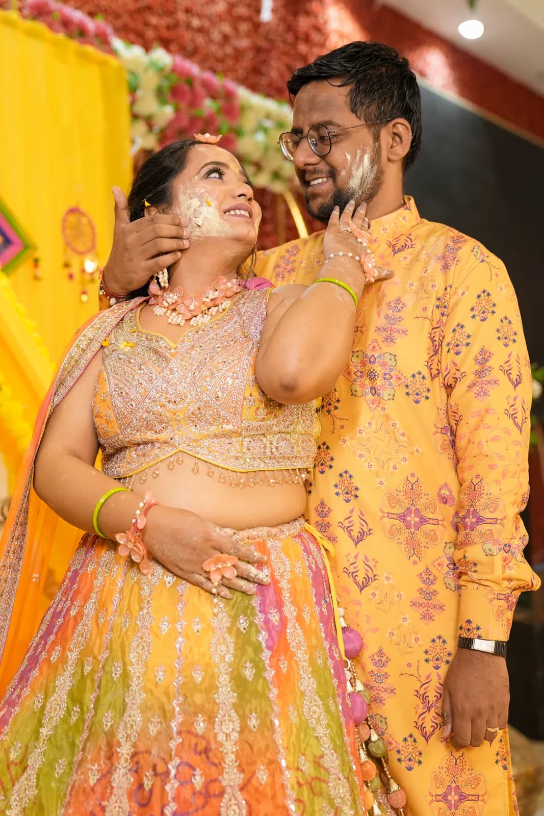 Haldi ceremony moment in yellow — candid wedding photography by Lens9 Studio, New Delhi
