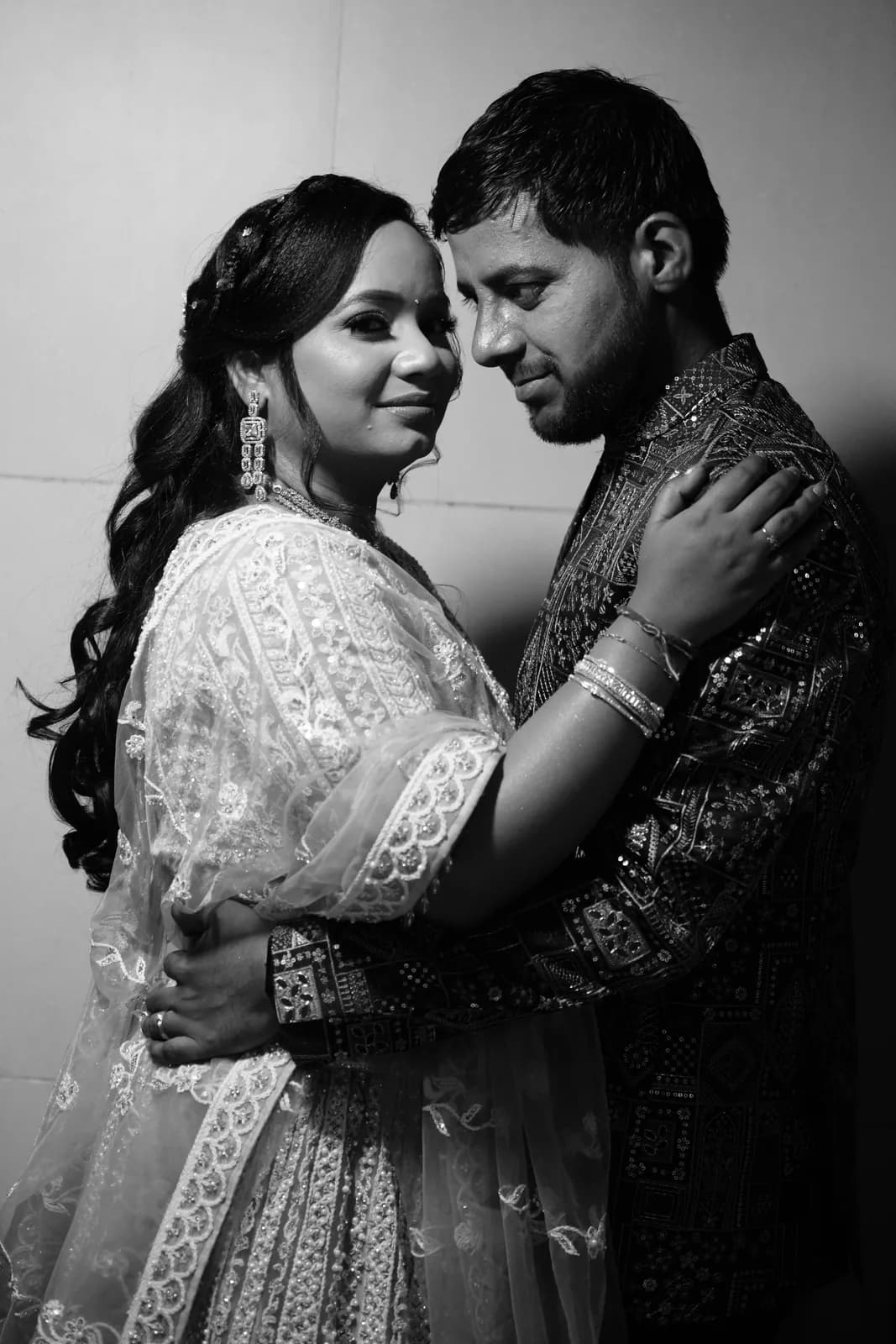 Black-and-white portrait of a couple embracing — candid wedding photography, Lens9 Studio, New Delhi