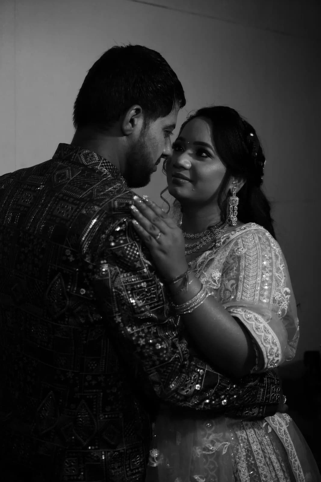 Colorful Rajasthani bride and groom with desert sand dunes and temple spires