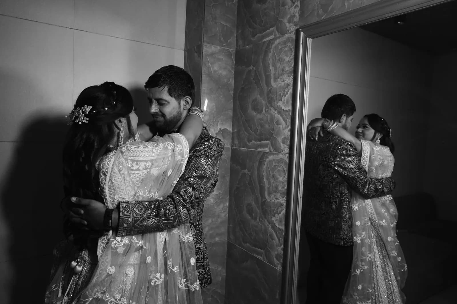 Couple embracing by Naini Lake during golden hour with misty Himalayan forested slopes behind