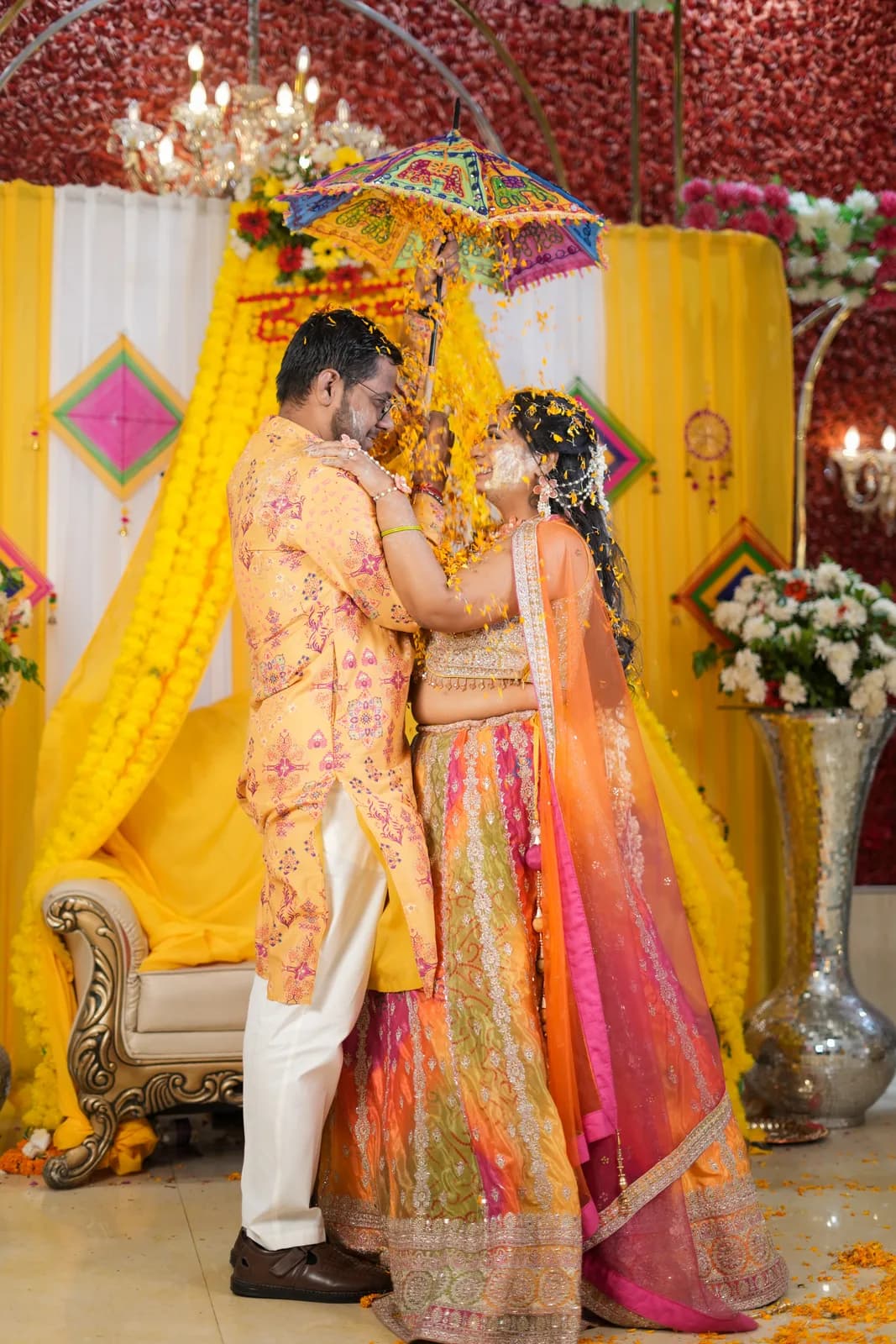 Bride dancing with family at sangeet celebration, colourful lights and joyful energy