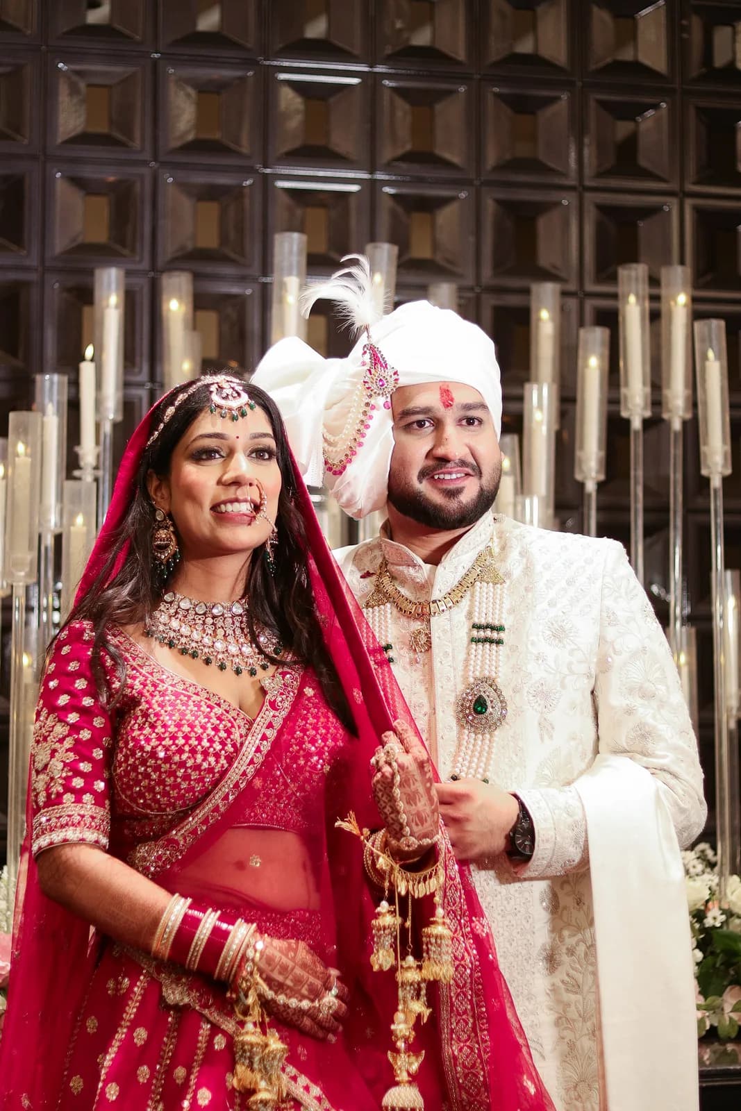 Couple in red and white wedding outfits — candid wedding photography, Lens9 Studio, New Delhi