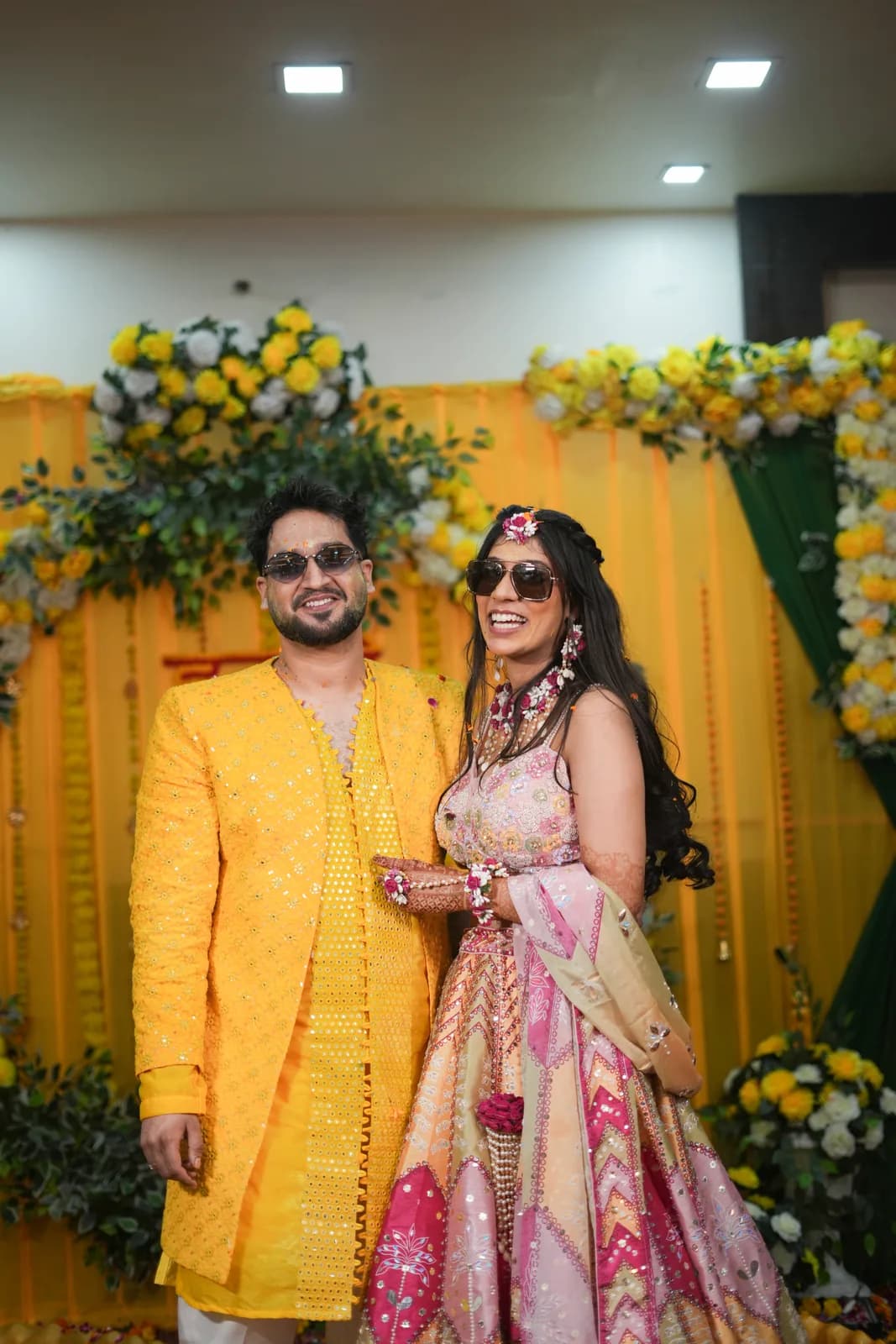 Bride and groom posing for a candid moment at an Indian wedding venue during golden hour photography session.