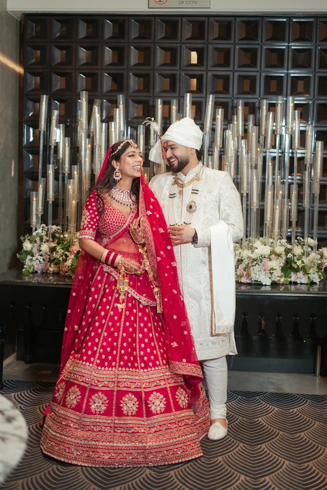 Couple in traditional red wedding attire — Lens9 Studio, New Delhi