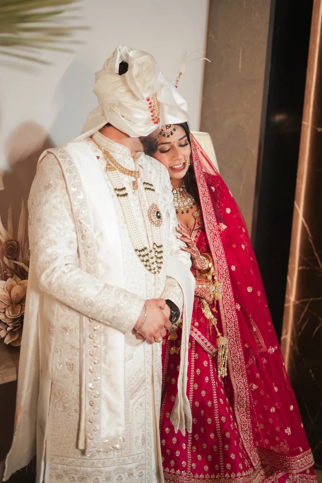 Couple in white and red wedding attire — Lens9 Studio, New Delhi